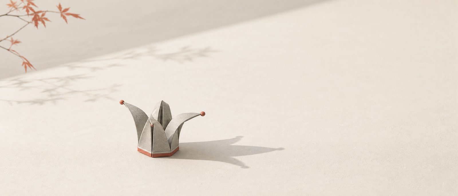 An origami jester hat resting in soft morning light